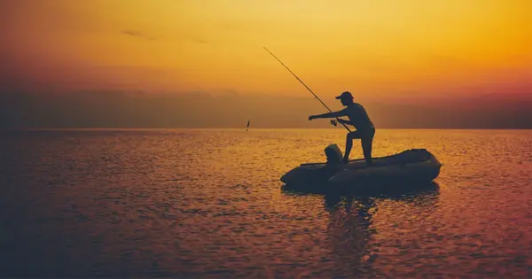 man fishing in a raft