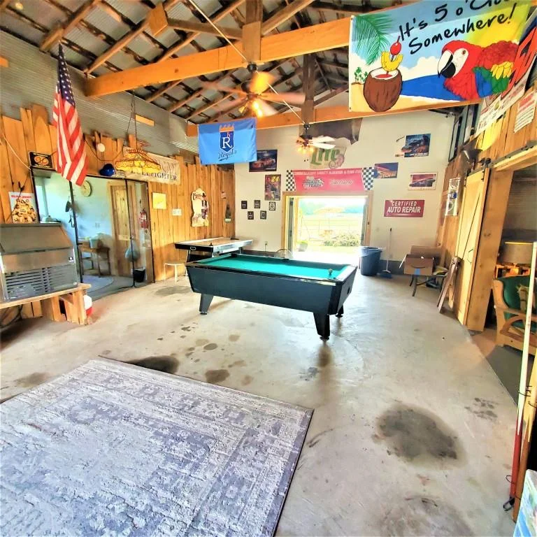 view of the pool table inside the barn at sidetrack rv park
