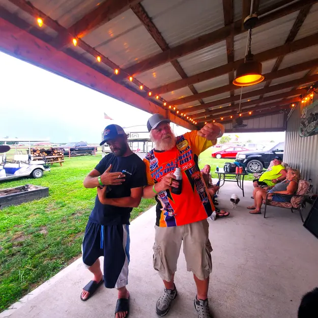 two cool guys posing on the back porch of the barn at sidetrack rv park